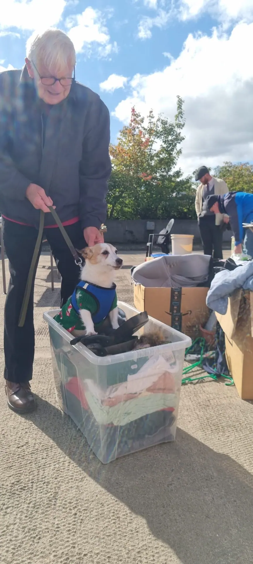 Customer with their dog at a car boot sale