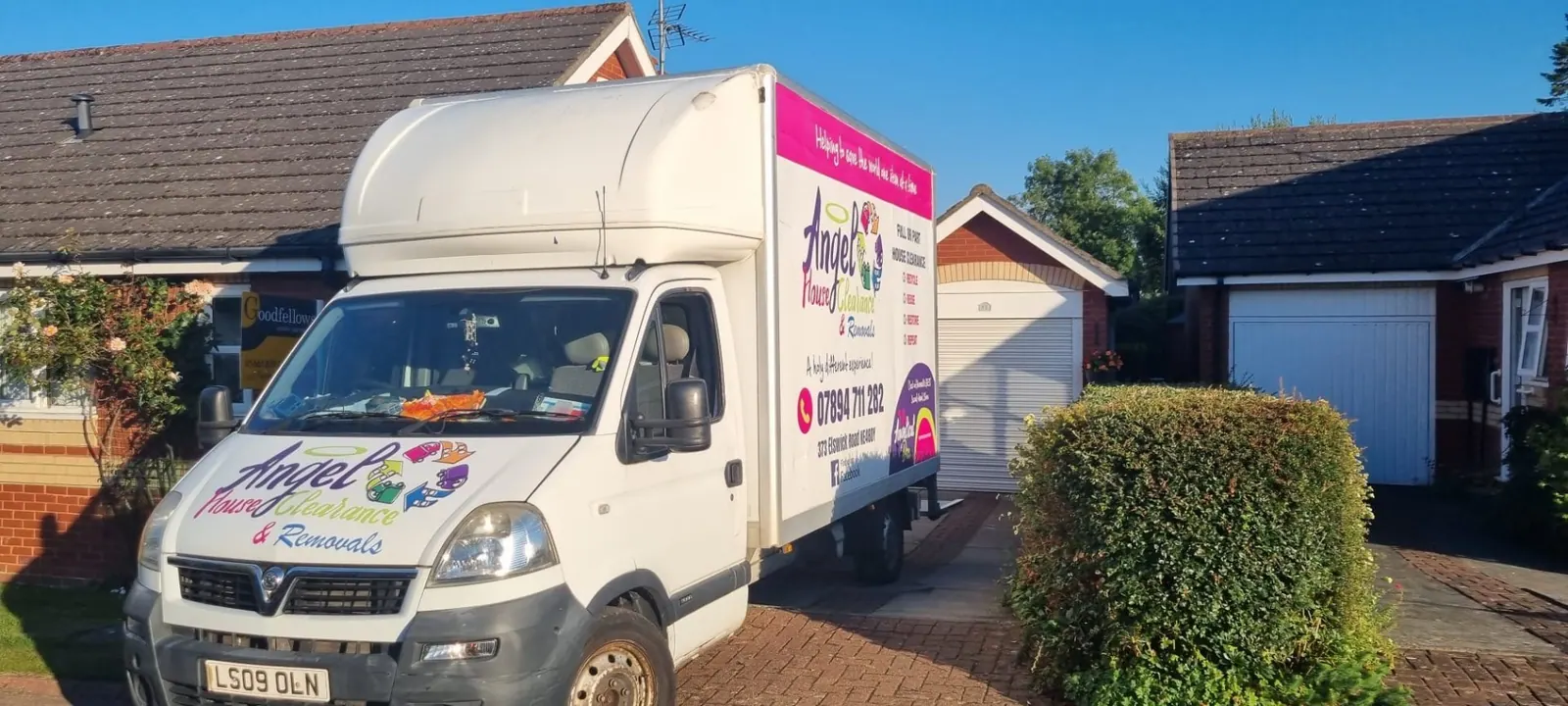 Angel House Clearance branded lorry outside a property