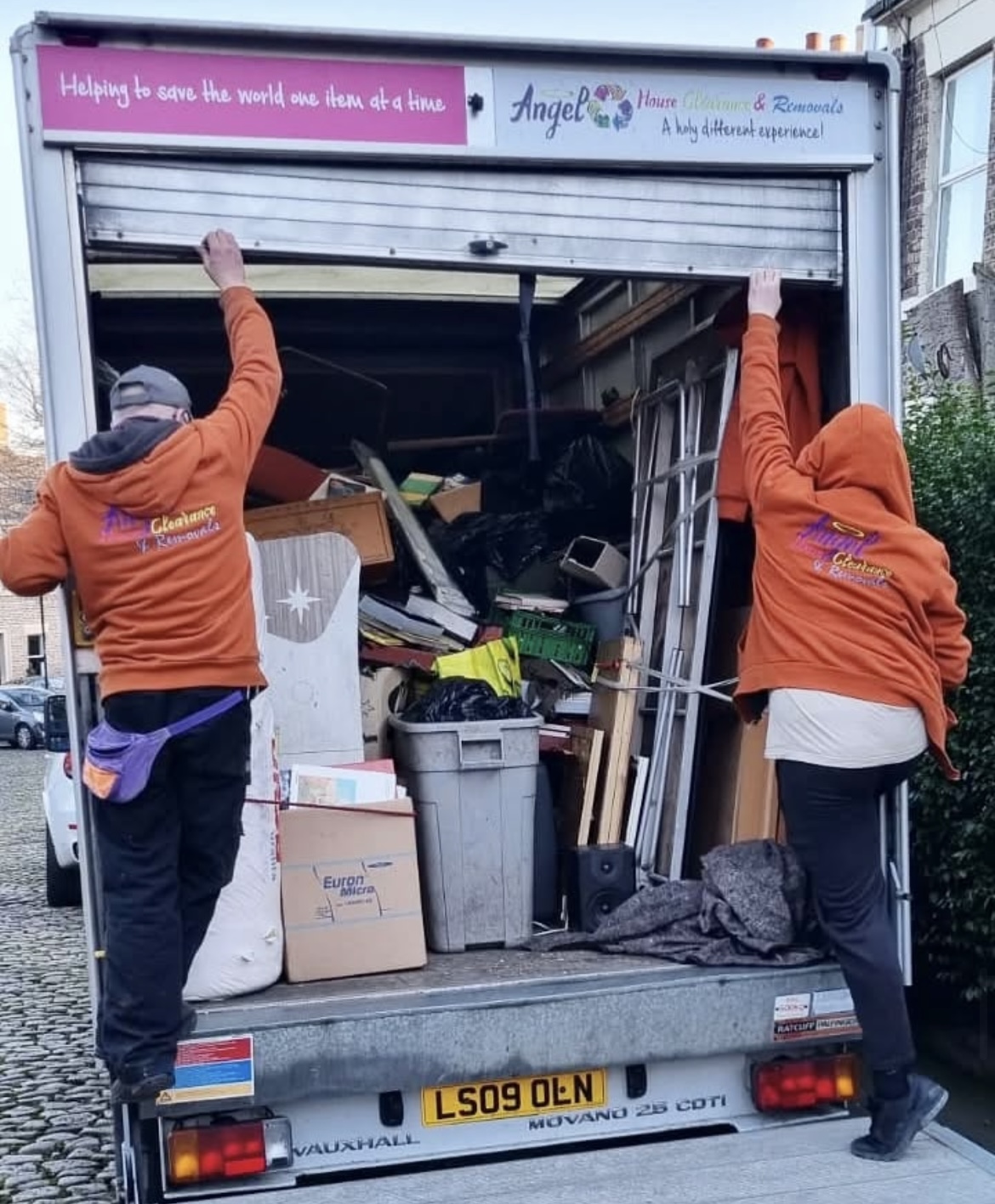 angel house clearance van loaded with items from a house clearance with 2 staff closing the tail gate